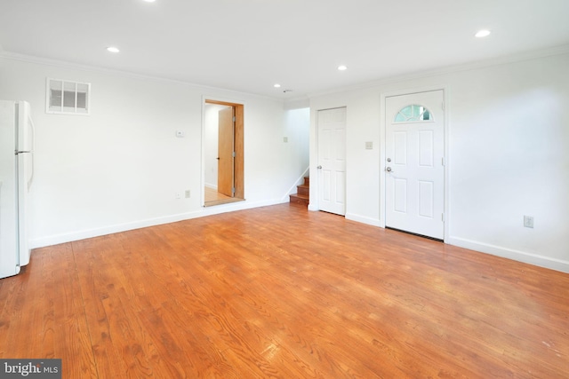 empty room with ornamental molding, recessed lighting, stairs, and visible vents