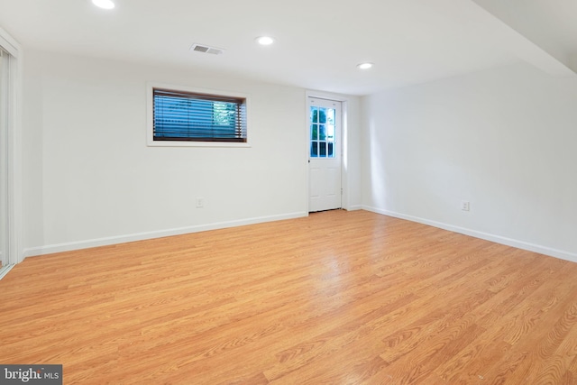 unfurnished room with recessed lighting, baseboards, visible vents, and light wood-type flooring