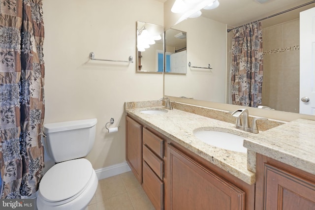 bathroom with a sink, tile patterned floors, baseboards, and toilet