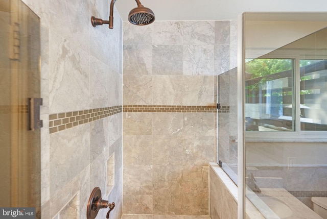 full bath featuring a tile shower and toilet
