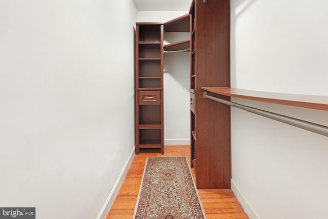 walk in closet featuring light wood finished floors