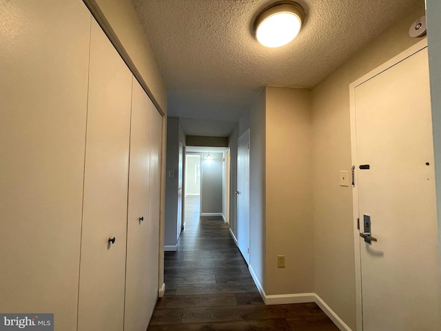 200 N Pickett St Unit 1412, Alexandria, VA 22304 - hallway featuring a textured ceiling, baseboards, and dark wood-type flooring