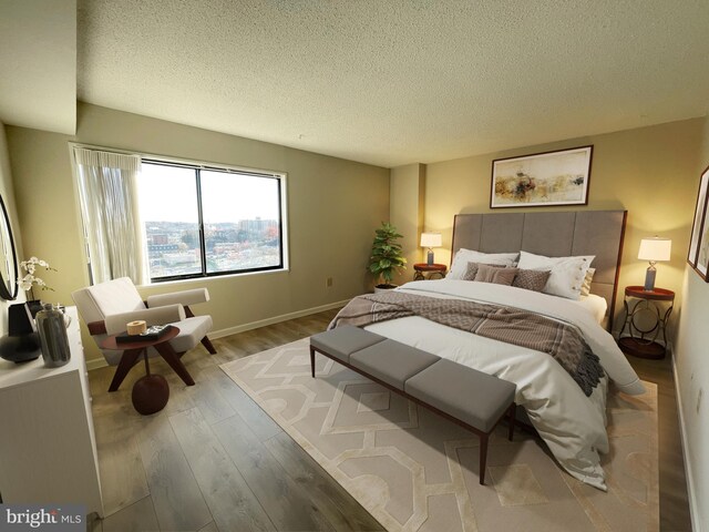 200 N Pickett St Unit 1412, Alexandria, VA 22304 - bedroom with a textured ceiling, baseboards, and wood finished floors