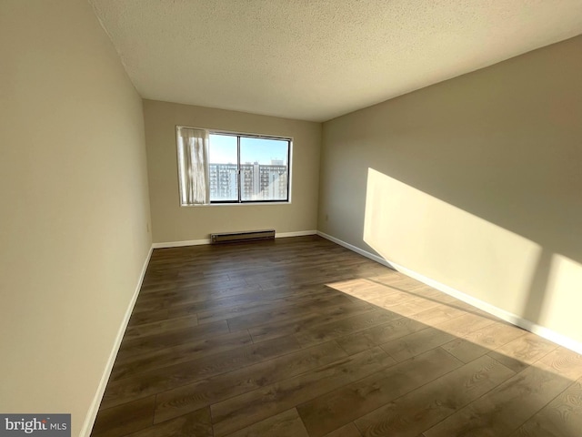 200 N Pickett St Unit 1412, Alexandria, VA 22304 - spare room featuring baseboards, a baseboard radiator, dark wood-style flooring, and a textured ceiling
