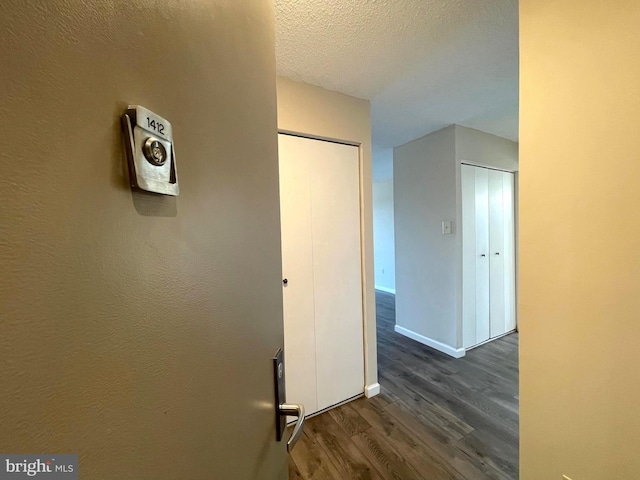200 N Pickett St Unit 1412, Alexandria, VA 22304 - hall featuring baseboards, a textured ceiling, and dark wood finished floors