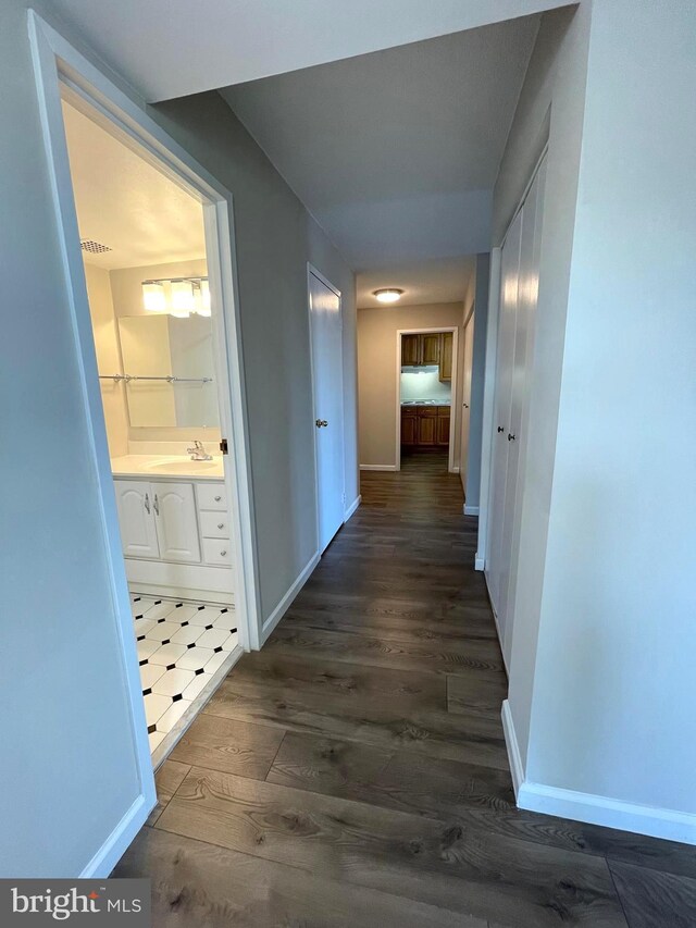 200 N Pickett St Unit 1412, Alexandria, VA 22304 - hallway with dark wood-type flooring, a sink, and baseboards