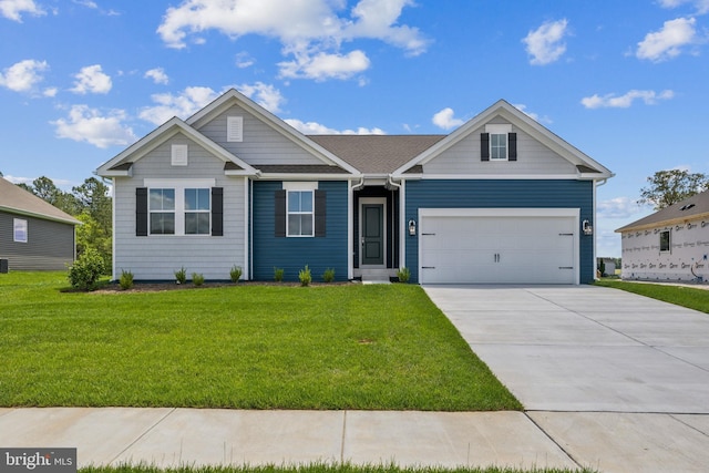 view of front of property featuring concrete driveway, a front yard, and a garage