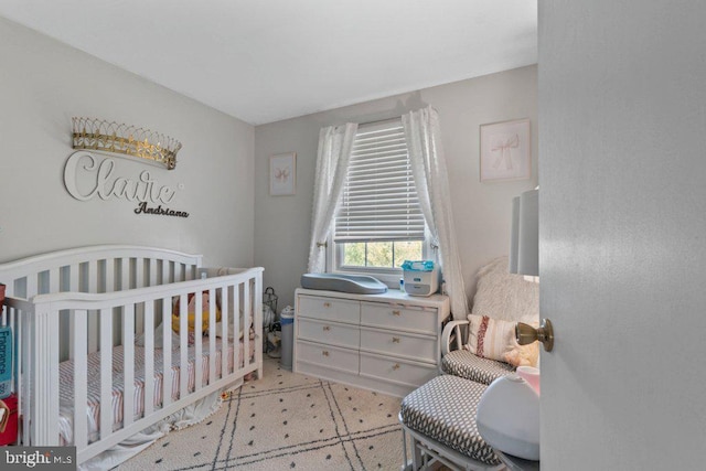 bedroom featuring a crib