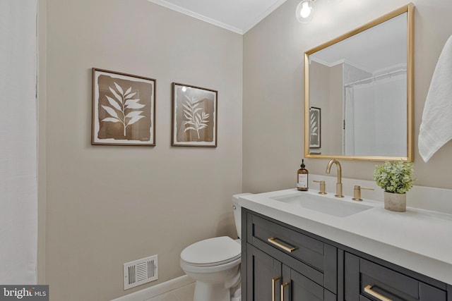 bathroom featuring ornamental molding, vanity, toilet, and baseboards