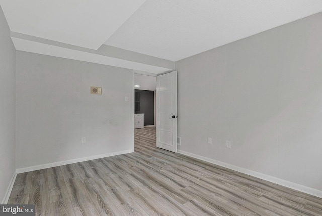 empty room featuring wood finished floors and baseboards