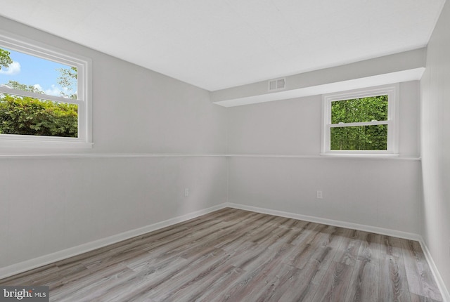 empty room with light wood-style flooring and baseboards