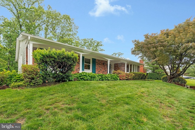 ranch-style home with brick siding and a front lawn