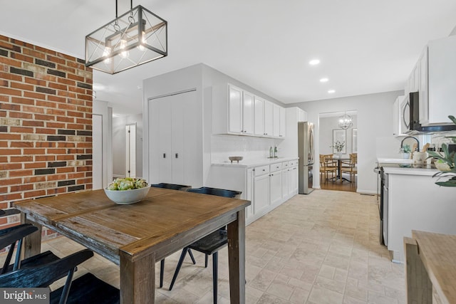 dining space featuring a chandelier and recessed lighting