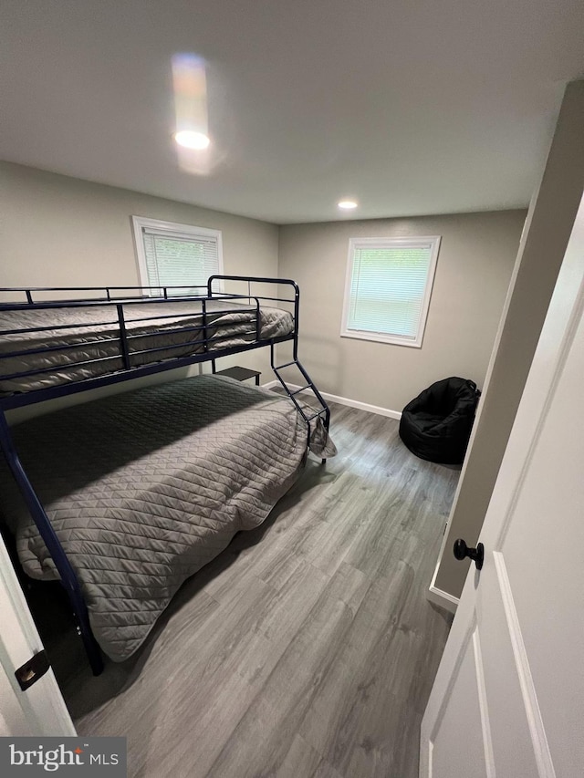 bedroom with baseboards, recessed lighting, and wood finished floors