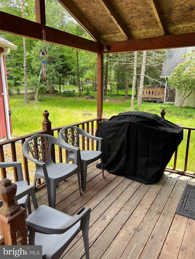 deck featuring a yard and grilling area