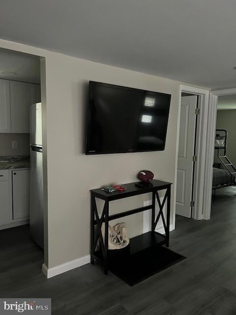 room details with baseboards, freestanding refrigerator, and wood finished floors