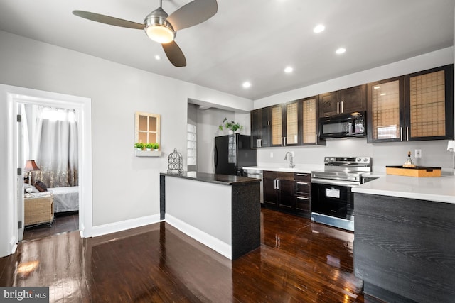 3700 13th St NW, Washington, DC 20010 - kitchen featuring black appliances, dark wood-type flooring, ceiling fan, recessed lighting, and glass insert cabinets