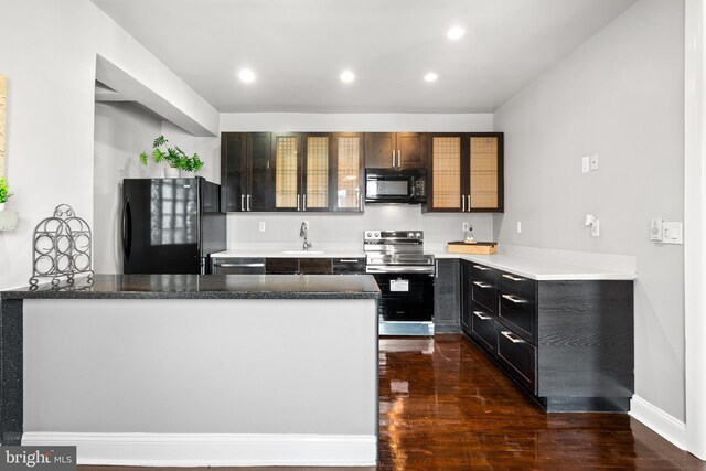 3700 13th St NW, Washington, DC 20010 - kitchen featuring black appliances, dark wood-style floors, a peninsula, recessed lighting, and glass insert cabinets