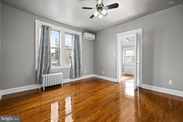 3700 13th St NW, Washington, DC 20010 - unfurnished room featuring radiator heating unit, a wall unit AC, ceiling fan, and wood finished floors