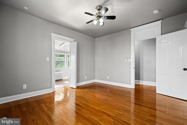 3700 13th St NW, Washington, DC 20010 - empty room featuring radiator heating unit, a smoke detector, ceiling fan, and wood finished floors
