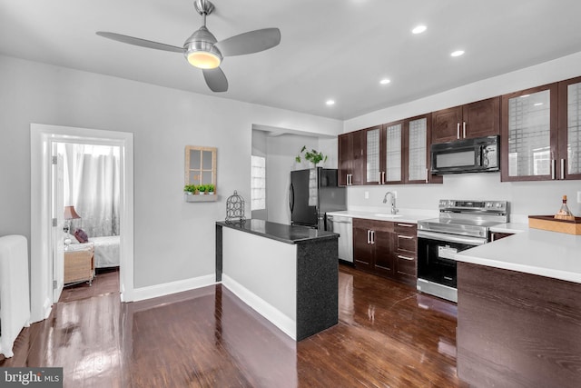 3700 13th St NW, Washington, DC 20010 - kitchen featuring black appliances, glass insert cabinets, dark wood-type flooring, dark brown cabinetry, and recessed lighting