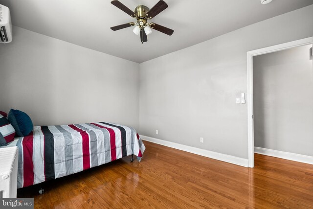 3700 13th St NW, Washington, DC 20010 - bedroom with wood finished floors, a ceiling fan, and a wall mounted air conditioner