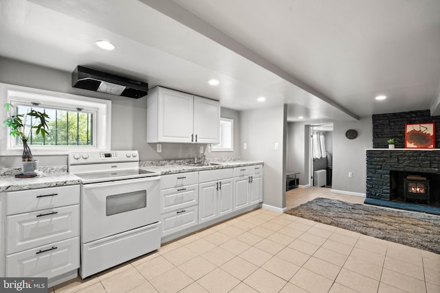 3700 13th St NW, Washington, DC 20010 - kitchen with electric range, exhaust hood, recessed lighting, white cabinetry, and light tile patterned floors