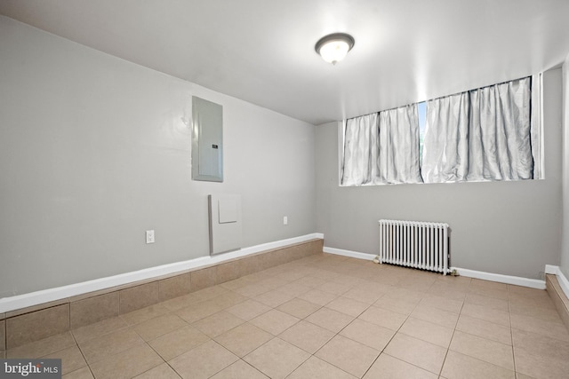 3700 13th St NW, Washington, DC 20010 - spare room featuring radiator heating unit, electric panel, and tile patterned floors