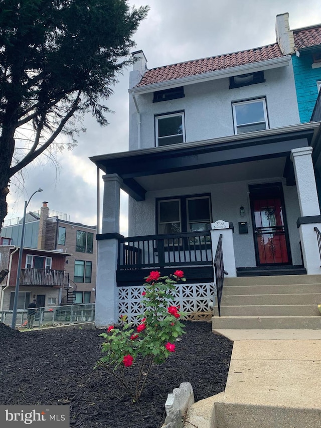 3700 13th St NW, Washington, DC 20010 - view of front of property featuring a porch, a tiled roof, stucco siding, and a chimney