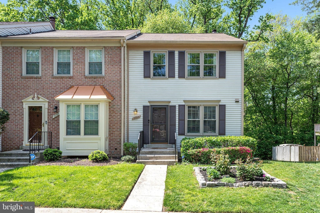view of property featuring a front lawn