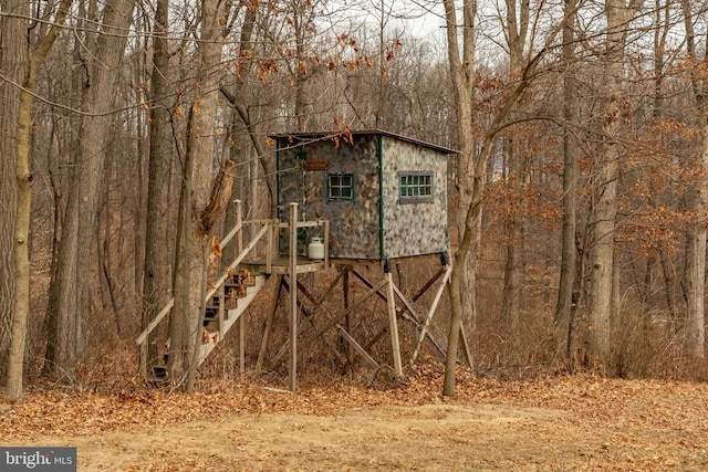 view of outbuilding with a forest view
