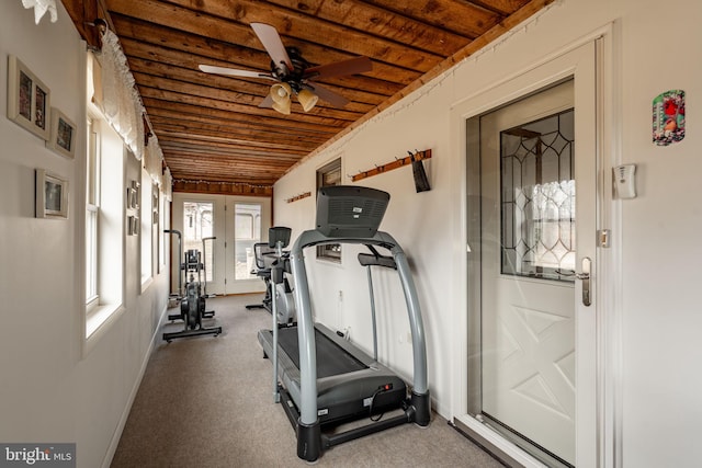 workout area featuring carpet, wooden ceiling, baseboards, and ceiling fan