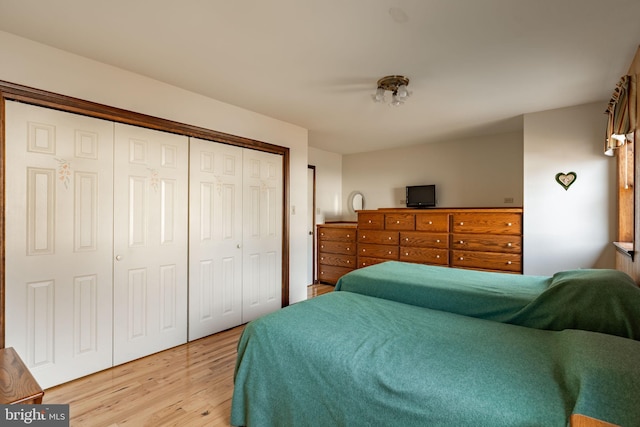 bedroom featuring a closet and light wood-style floors