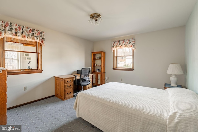 carpeted bedroom featuring baseboards