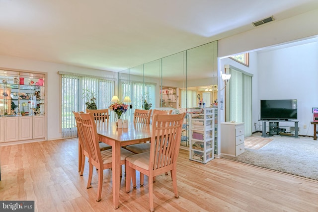 dining room with wood finished floors and visible vents