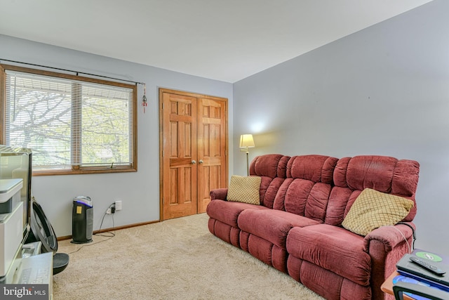 living area with carpet floors and baseboards