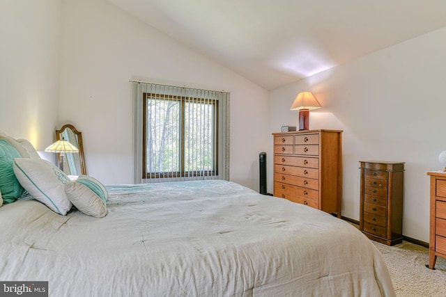 bedroom with vaulted ceiling and carpet