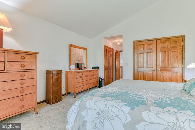 bedroom with light colored carpet and vaulted ceiling