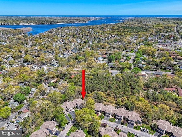 drone / aerial view featuring a water view and a residential view