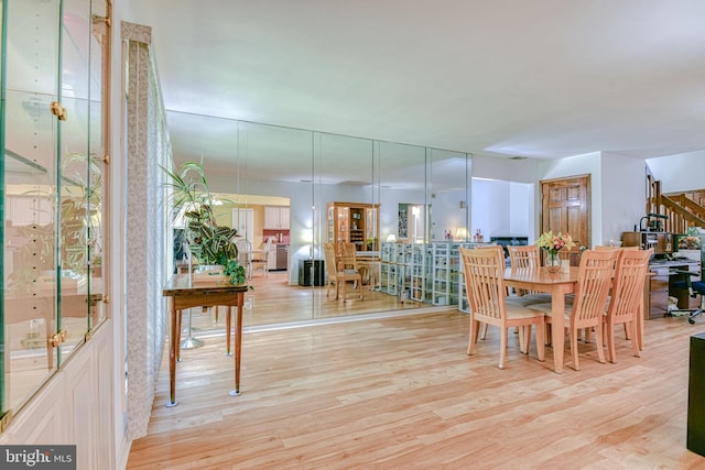 dining area with stairway and wood finished floors