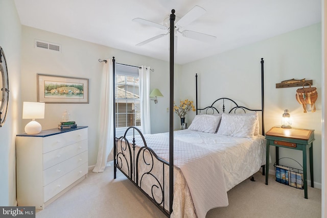 bedroom with visible vents, ceiling fan, and light colored carpet