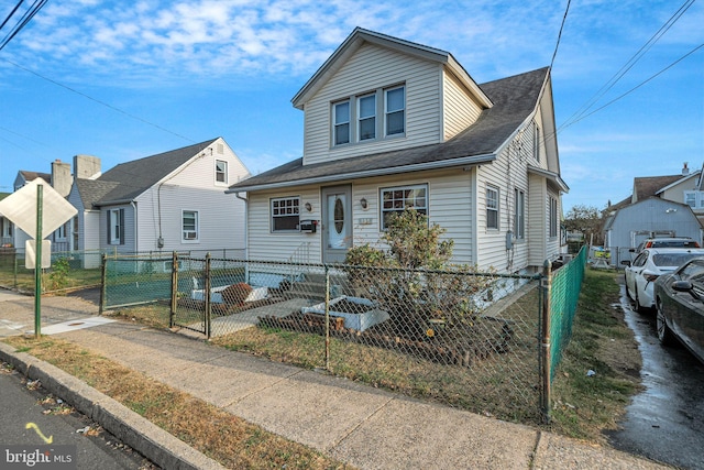 bungalow-style home featuring a gate and a fenced front yard