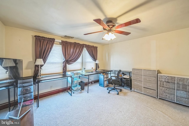 office area with carpet flooring, a ceiling fan, and visible vents