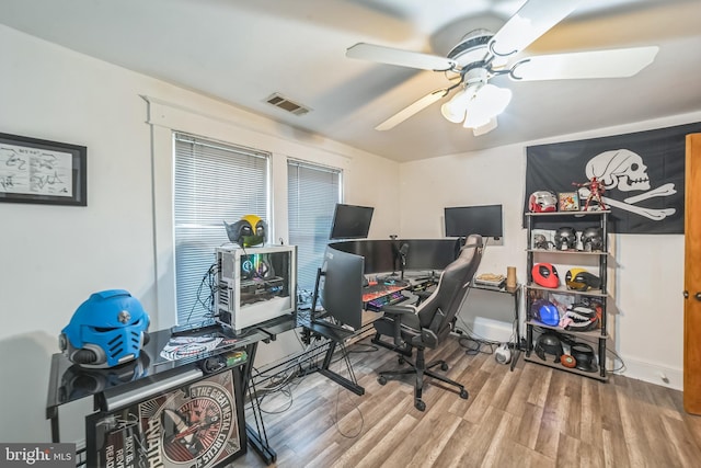 office space featuring a ceiling fan, wood finished floors, and visible vents