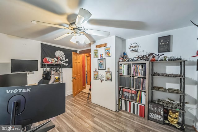 interior space with ceiling fan and wood finished floors