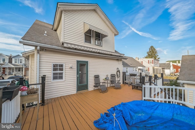 deck featuring a residential view and cooling unit