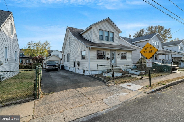 bungalow-style house with roof with shingles, aphalt driveway, a detached garage, an outdoor structure, and fence private yard