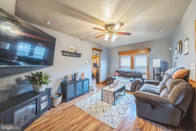 living room with a ceiling fan, recessed lighting, and wood finished floors