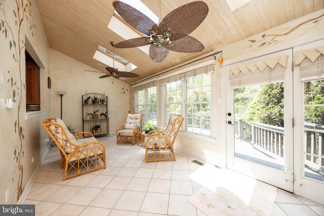 sunroom with tile patterned flooring, wood ceiling, lofted ceiling with skylight, and a wealth of natural light