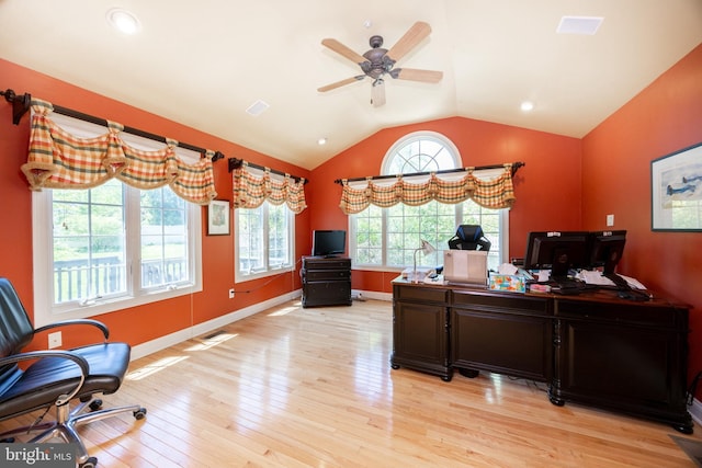 office area featuring vaulted ceiling, a ceiling fan, visible vents, and light wood-style floors
